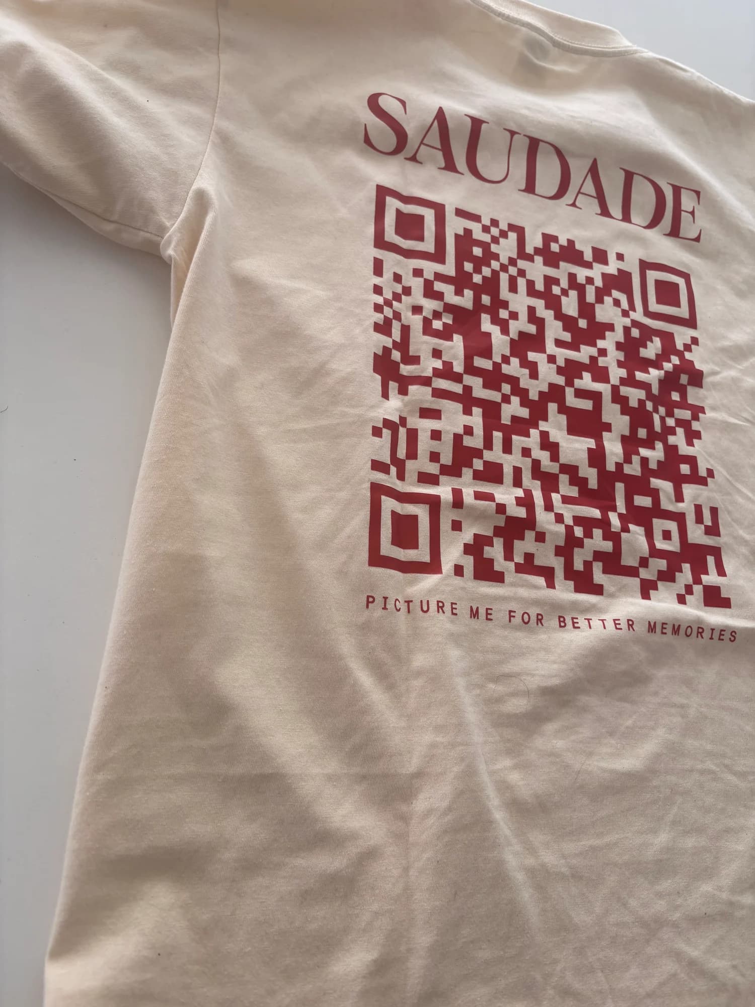 The physical Saudade T-shirt with its printed QR code