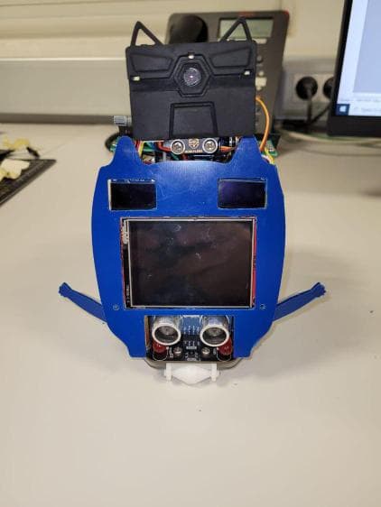 A-BOT prototype with a blue cat-shaped body, displays and front sensors
